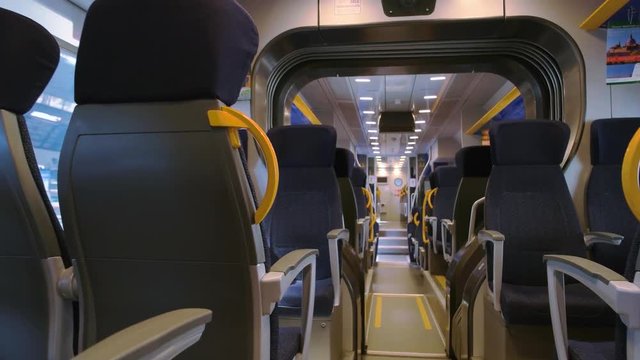 Inside modern passenger train. Train wagon seats. Fastest public transport.