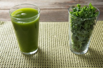 Fresh kale juice and leaves in glasses