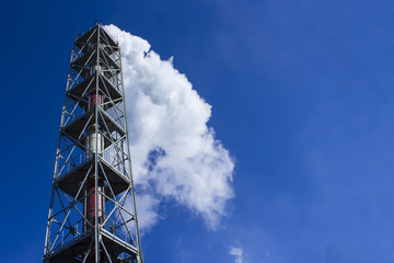 smoke from factory chimneys on a sky background