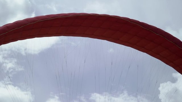 Paraglider red wing at sunny day