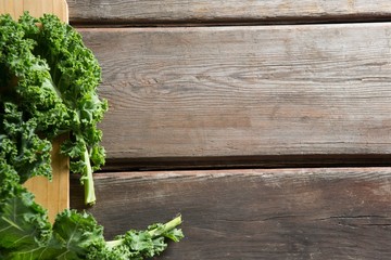 Fresh kale leaves on wooden board