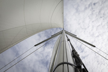 Fototapeta premium Masts peak of a sailboat with cloudy sky