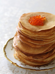 ruddy fried pancakes with red caviar