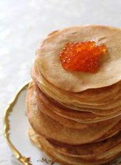 ruddy fried pancakes with red caviar