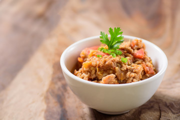 Northern Thai food (Nam Prik Ong) on wooden background,spicy tomato with pork,red chili dip,Northern Thai dipping sauce