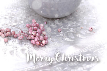 Fototapeta na wymiar merry christmas pink berries on silver plate with snow