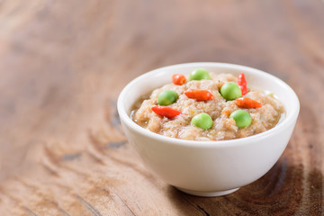 Thai food (Nam Prik Kapi),shrimp paste chili dip in a bowl on wooden background