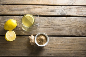 Obraz na płótnie Canvas Herbal tea cup with lemon and ginger on table