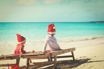 kids celebrating christmas on tropical beach