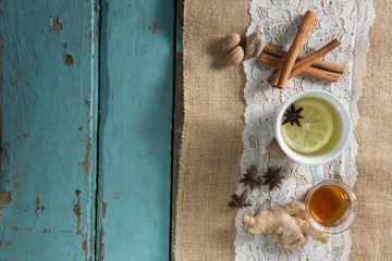 Overhead view of cinnamons with ginger tea on burlap