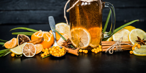 the composition of tea with lemon on a black background