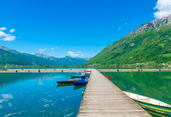 Foto op Canvas A picturesque mountain lake is located in a valley among the mountains. © Sergej Ljashenko