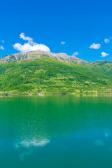 A picturesque mountain lake is located in a valley among the mountains.