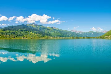 Zelfklevend Fotobehang A picturesque mountain lake is located in a valley among the mountains. © Sergej Ljashenko