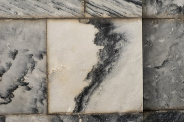 The texture of the brushed stone, marble. Different shades of gray with splotches, stripes, lines. Close-up