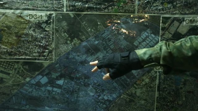 Close up shot of an officer's hand pointing to certain things on a map