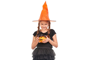 Portrait of little girl with braids posing in Halloween costume against white background