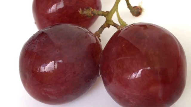Smoll Red Grapes White background wet water droplet, authentic motion rain water droplets natural fruti