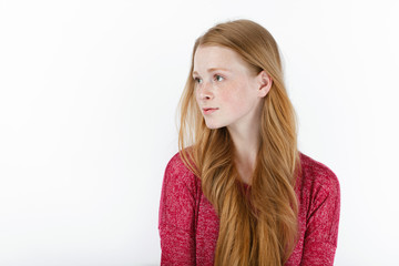 Beauty portrait of young adorable fresh looking redhead woman with gorgeous extra long hair. Emotion and facial expression concept.