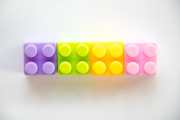 Multi color square plastic toy block on white background