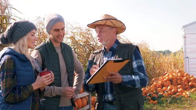 Farmer give couple some guidance as to how segregate pumpkins