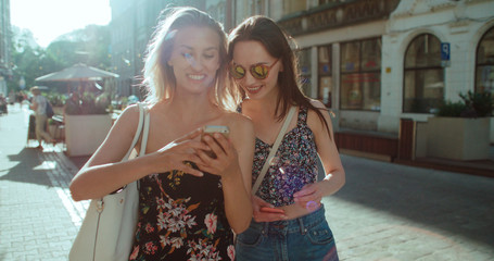 Beautiful young women watching photos on a mobile phone.