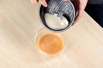 coconut jam mix with egg on wooden table
