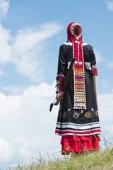 archery girl shoots in ethnic ancient clothes. Bashkir nationality.