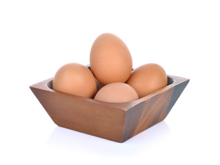 egg in a wooden bowl isolated on white background