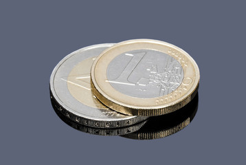 Coins of one and two Euro on a gray background closeup
