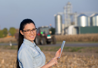Farmer woman with tablet and silos © Budimir Jevtic