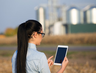 Farmer woman with tablet and silos © Budimir Jevtic