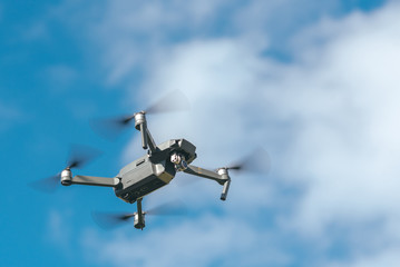 Flying drone on blue sky background