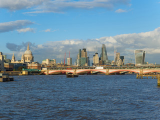 Fototapeta na wymiar London skyline with a view of the River Thames, St Paul's Cathedral, Blackfriars Bridge and skyscrapers of the City on a sunny afternoon.