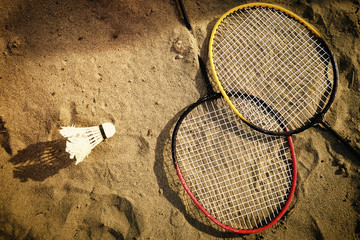 Badminton rackets in the sand of the beach