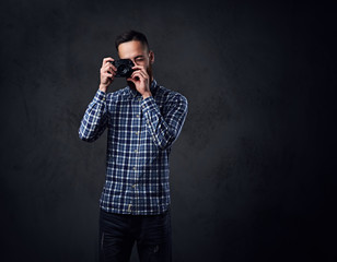 A man taking pictures with a compact camera.