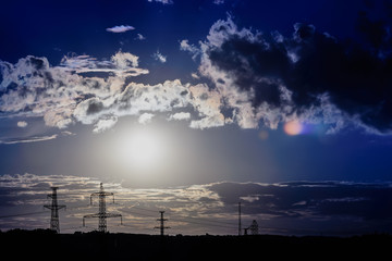 Dramatic cloudy sky at sunset with skyline silhouette. cold color