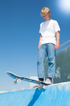 Young teen boy who skates on a ramp