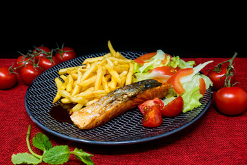 grilled salmon with sauce lemon and tomato