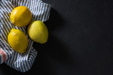 Three fresh lemons on textile