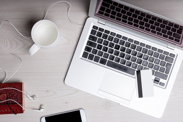 mess on a table with laptop and smartphone