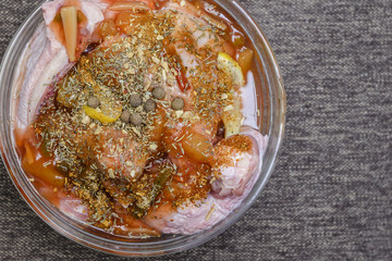 Raw meat marinated in seasonings, in a glass plate