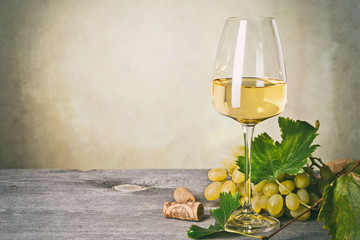 Glass of white wine on vintage wooden table