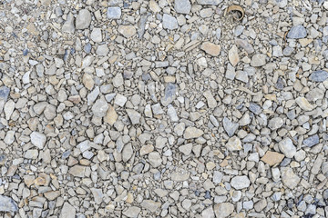 Texture of stones with sharp edges piled on the sidewalk