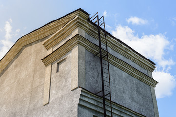 Wall of an old building with a fire escape