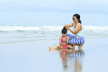 mother and daughter on the beach,tavel holiday vacation lifesthyle family concept