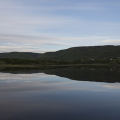 Scenic view of calm river with mountains in background, Cheticamp, Cabot Trail, Cape Breton Island, Nova Scotia, Canada