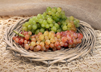 Juicy fresh red and white grapes  in a wattled basket