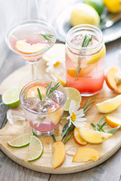A tray of summer iced fruit drinks on a table outside.