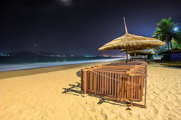 Night on a sand beach, umbrella